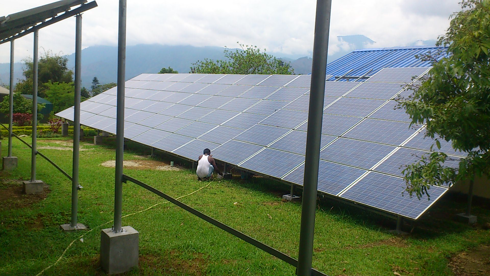 Solar engineer inspecting panels on rooftop